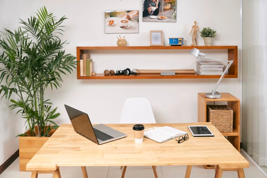 Opened laptop, digital tablet, planner and cup of coffee for article about the easiest work at home jobs that require no experience